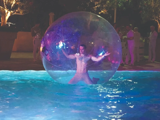 Male entertainer in a bubble over a swimming pool, StepFlix Entertainment, Miami, FL.