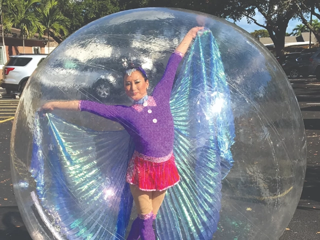 Female entertainer in a bubble over a swimming pool, StepFlix Entertainment, Miami, FL.