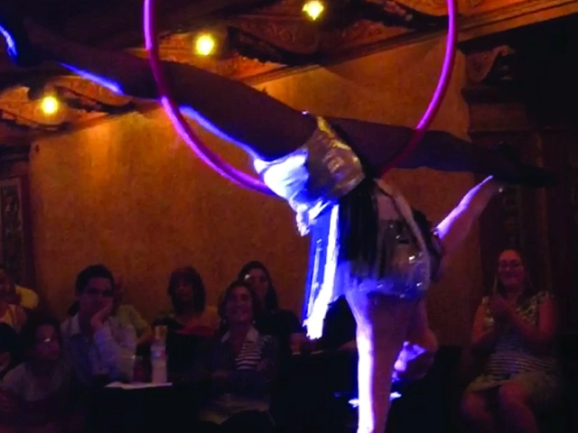 Aerialist performing on a lyra hoop at a party in Miami, FL by StepFlix Entertainment.