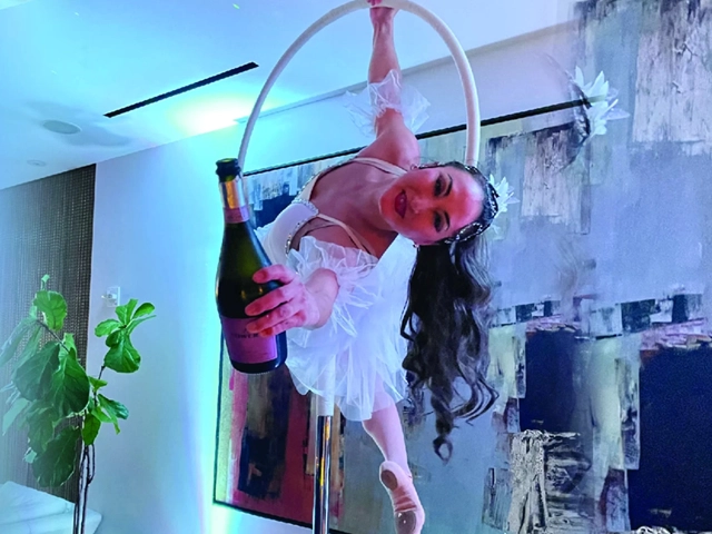 Standing lyra performer with champagne in hand, StepFlix Entertainment, Miami, Florida.